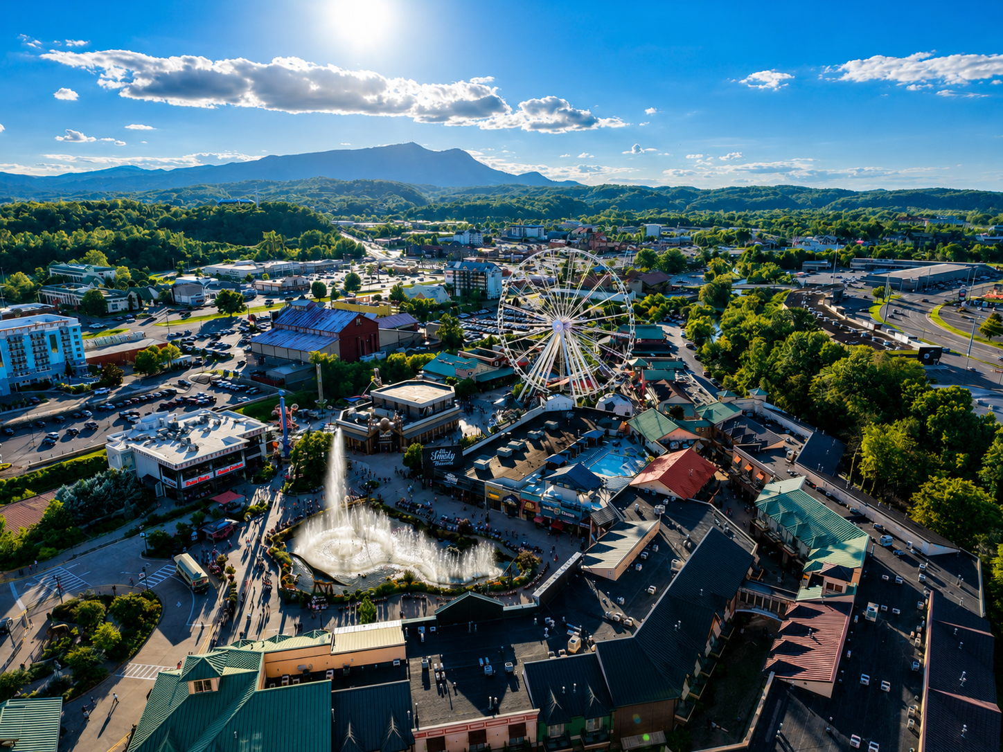 Aerial view of entertainment district with ferris wheel and fountain