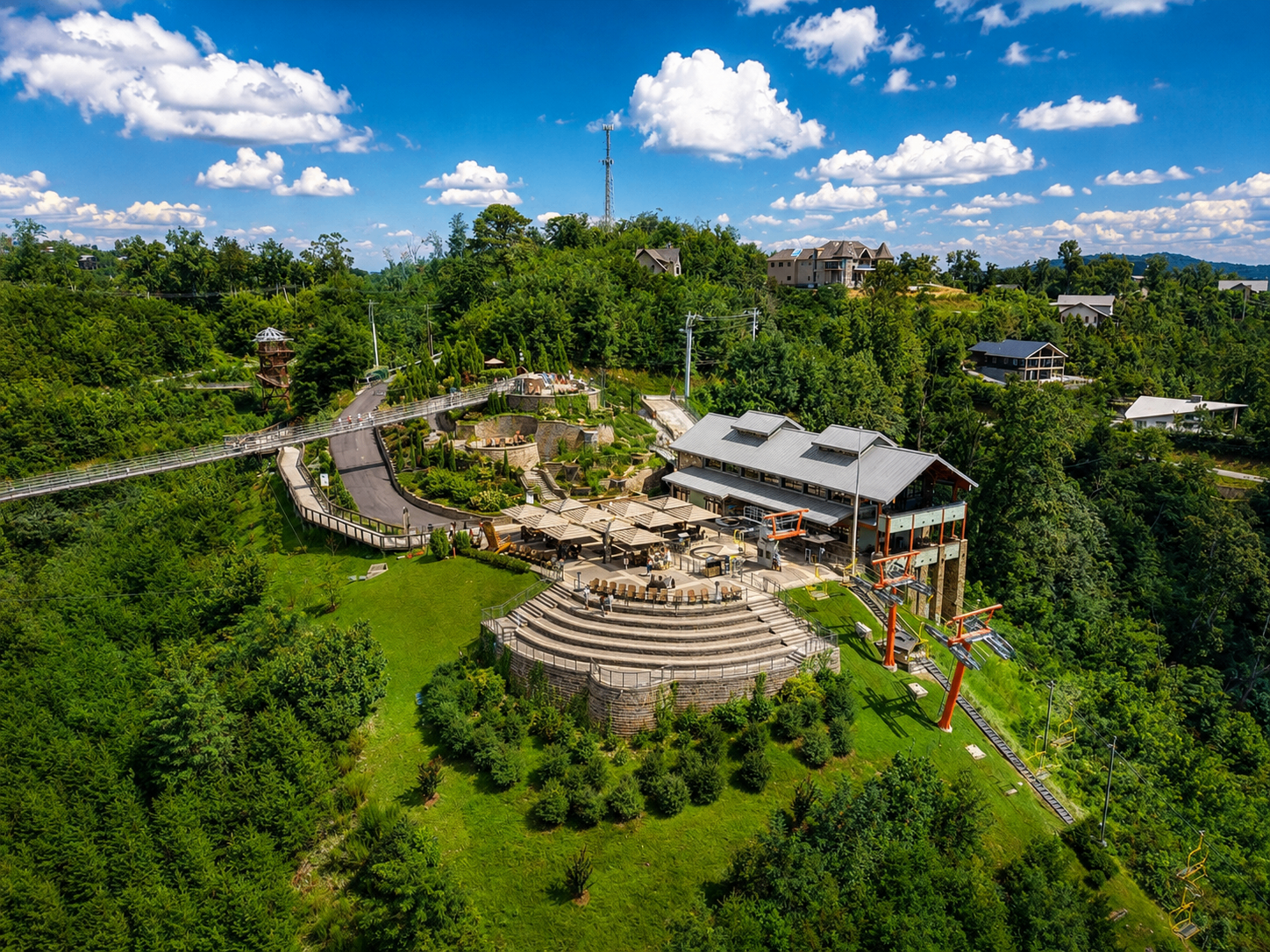 Aerial view of mountaintop resort with chairlift and skybridge